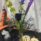 Local made withches hat with black rose vase arrangement