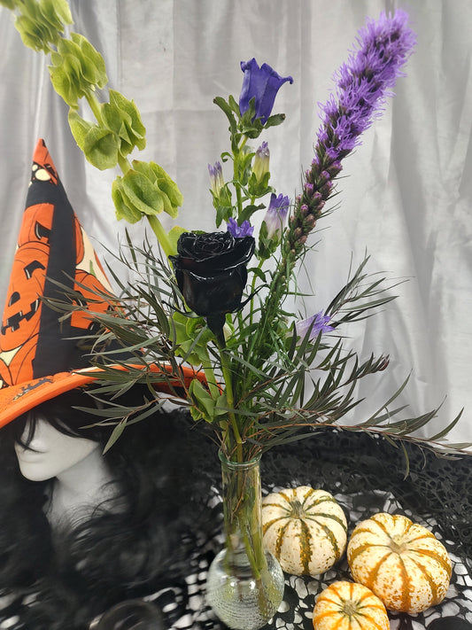 Local made withches hat with black rose vase arrangement